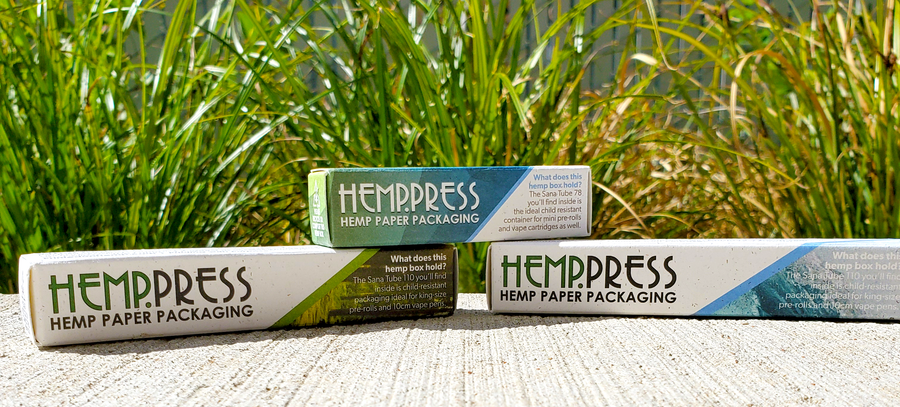 Hemp paper packaging samples for pre roll tubes photographed outdoors.